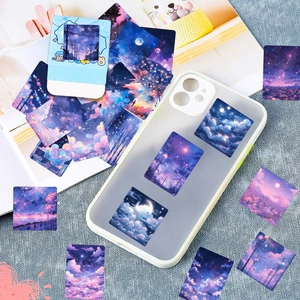 Detail of dreamy starry sky aesthetic stickers applied on a phone case and journal