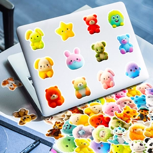 Detailed close-up of 3D effect cartoon plush bear stickers on a laptop surface