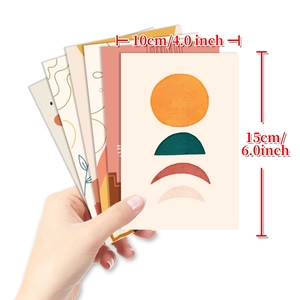 Detail showing hand holding 10x15cm minimalist boho wall decor cards with sun and moon art