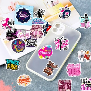 Close-up of waterproof dance and music stickers on a notebook and phone case