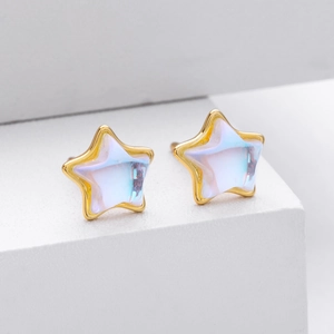 Macro view of star-shaped S925 silver stud earrings with iridescent moonstone finish
