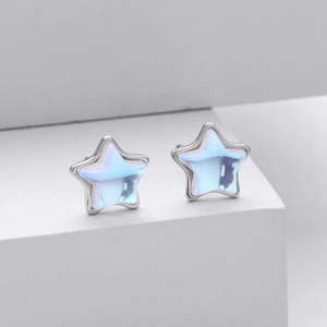 Close-up of S925 sterling silver star stud earrings with translucent moonstone inlays