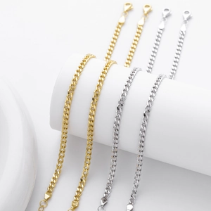Detailed view of classic silver and gold Cuban link bracelets with lobster clasps