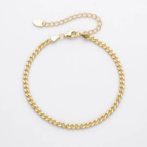 Close-up of golden S925 sterling silver curb chain bracelet with lobster clasp and tag