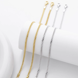 Detailed view of silver and gold cuban link chains with classic lobster clasp closures