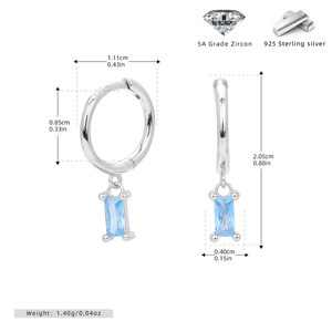 Macro detail of 925 sterling silver hoop earrings with rectangular blue zircon stones