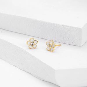 Vue macro détaillée de boucles d'oreilles fleur de cerisier en argent s925 et émail