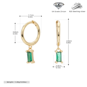 Macro detail of 925 sterling silver gold earrings with green 5A cubic zirconia stones