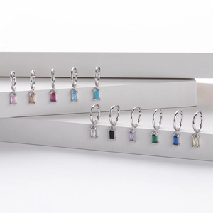 Set of s925 silver hoop earrings with baguette-cut colorful gemstones on white stands
