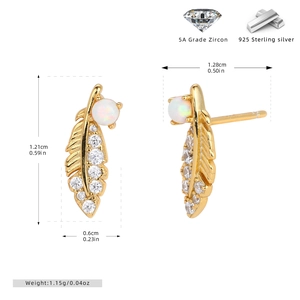 Detail of gold feather earrings in 925 sterling silver with zircon and opal inlay