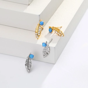 Detailed view of feather stud earrings with blue opal and small white zircons