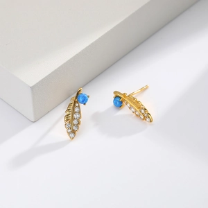 Detail of feather stud earring in gold with blue opal center and zircon stones