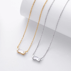 Close-up of gold and silver S925 sterling silver necklaces with baguette cut zircon