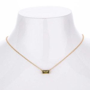 Macro detail of rectangle green zircon pendant on gold S925 sterling silver chain necklace