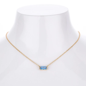 Detail of s925 silver necklace featuring a rectangular blue zircon pendant on a gold chain