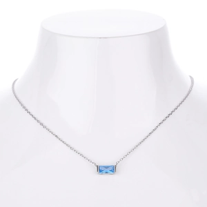 Detail of s925 silver necklace featuring a rectangular sky blue zircon pendant on model