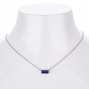 Detail of S925 silver necklace with rectangular blue zircon on a white neck model