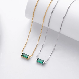 Close-up of square emerald zircon pendant on S925 silver chain in gold and silver finish