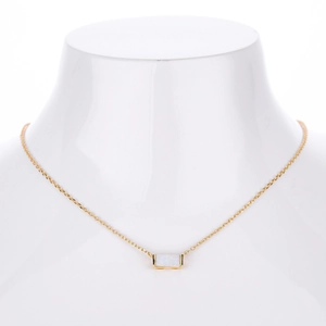 Detail of s925 gold necklace featuring a rectangular white opal pendant on neck model