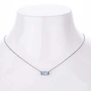 Macro shot of minimalist S925 silver necklace featuring a blue rectangular zircon pendant