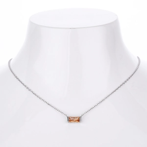 Detail of s925 silver necklace featuring a rectangular champagne zircon pendant on a model
