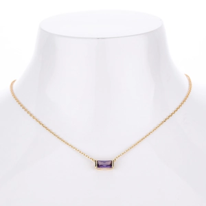 Detailed view of square purple zircon pendant on a delicate gold-plated silver chain