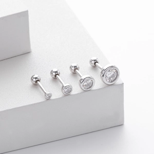 Détail de quatre boucles d'oreilles en argent S925 avec zircons et fermoirs à vis boules