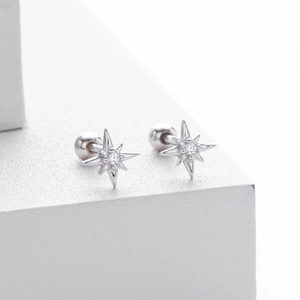 Macro view of S925 silver star stud earrings with zirconia and ball screw-back detail