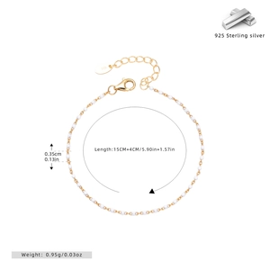 Detailed close-up of 925 sterling silver chain with white enamel beads and lobster clasp