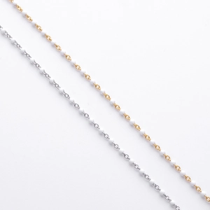 Detail of minimalist S925 silver and gold beaded bracelets with colorful enamel accents