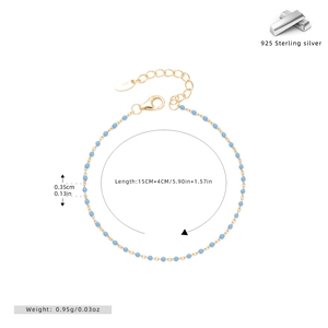 Detailed view of S925 sterling silver gold bracelet with blue enamel beads and 925 tag
