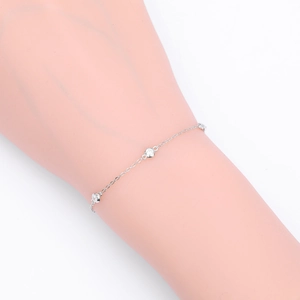 Close-up of a minimalist S925 sterling silver chain bracelet with three round clear stones