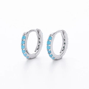 Detailed view of S925 sterling silver hoop earrings set with bright blue round stones