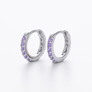 Macro shot of S925 sterling silver hoop earrings with prong-set purple zircon stones