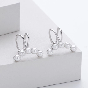 Detail of S925 sterling silver ear cuffs featuring five glossy white gradient pearls