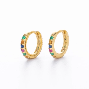 Detail of gold huggie earrings with multicolor vertical crystals on white background