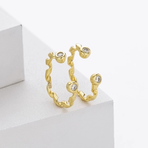 Close-up of S925 sterling silver earrings with twisted ribbon design and clear zircons