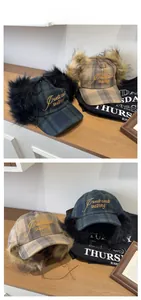 Detail of plaid earflap hats with West Coast Skating embroidery and faux fur lining
