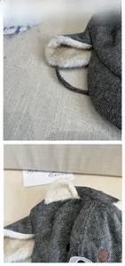 Detail of grey herringbone winter hat with plush faux fur lining and cute bear embroidery