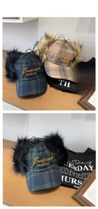 Close-up of plaid embroidery trapper hat with plush earflaps and West Coast skating logo