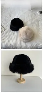 Close-up of thick faux fur bucket hat material showing plush texture in beige and black