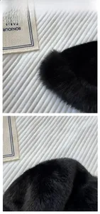 Detailed view of the fluffy black faux fur texture and dense plush fibers of the winter hat