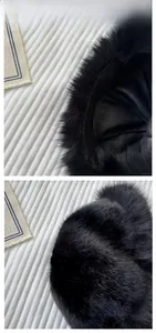 Close-up of black faux fur winter hat showing fluffy texture and soft inner lining