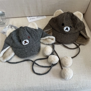 Winter plush trapper hat with bear ears and earflaps in grey and brown for warmth