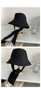 Detail view of black canvas sun hats in plain and polka dot styles with ribbons