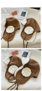 Detail of brown quilted trapper hat with white faux shearling lining and cozy ear flaps