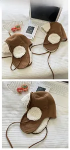 Detail view of quilted brown windproof fabric and warm white lamb wool lining on earflaps
