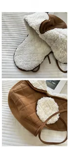 Detail view of winter trapper hat with diamond-quilted suede and thick faux shearling lining