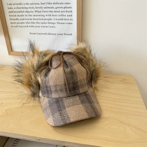 Brown plaid aviator hat with faux fur earflaps and a delicate leather bow tie