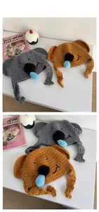 Detailed tile display of grey and brown knitted koala beanies with earflaps and tassels